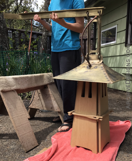 Large lantern in preparation for installation. The scale of the the lantern is very large, with 45 inches from the bottom of the white oak body, to the top of horizontal brass supporting arm. With all the solid brass and solid oak, the weight is very significant as well.