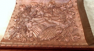 Copper kitchen hood, with repoussé. Grapevine motif.