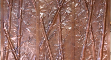 Bamboo repoussé fireplace surround in copper