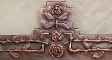copper mirror frame with repoussé roses by Archive Designs.