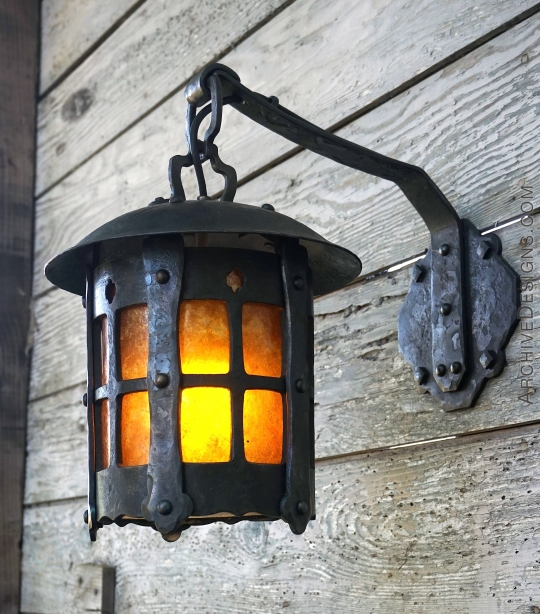 Forged lantern hanging from rustic wall