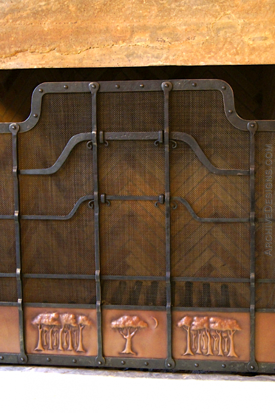 Front view of wrought iron fire screen with copper panels and trees in repoussé
