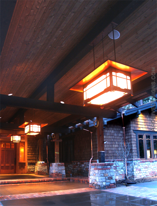 Row of grand-scale Greene & Greene-inspired copper lanterns above drive up area