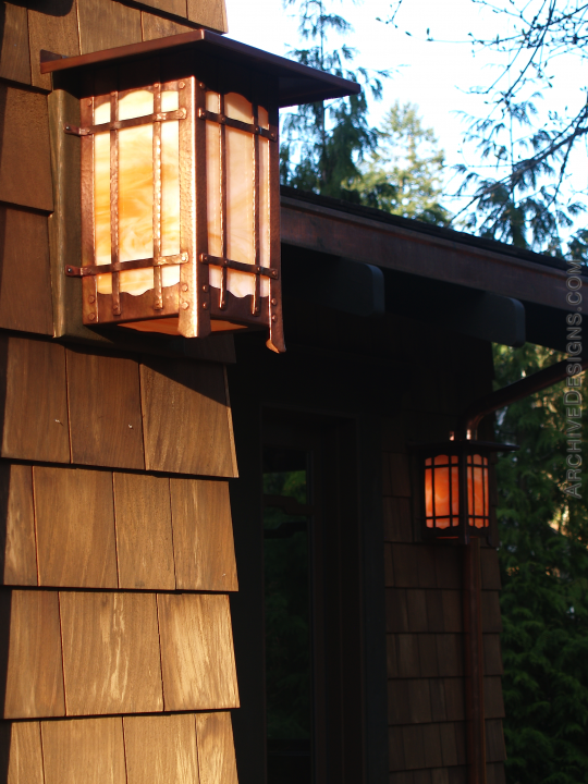 Greene & Greene-inspired copper wall lanterns during a fall sunset