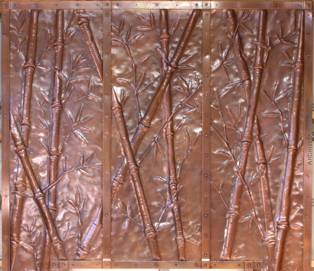Bamboo repoussé fireplace surround in copper