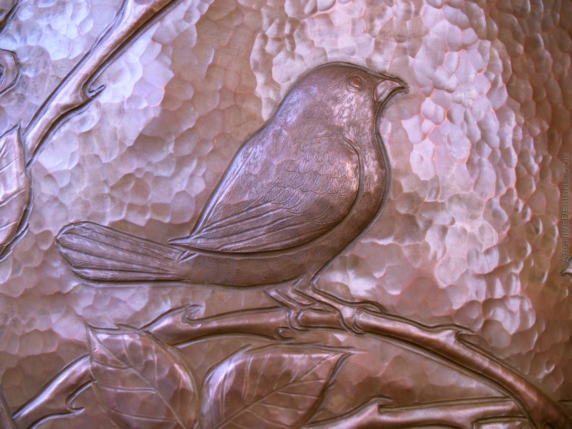 An exquisitely engraved Blackcapped-Chickadee in repoussé occupies a thicket of wild roses on a hammered copper vessel.