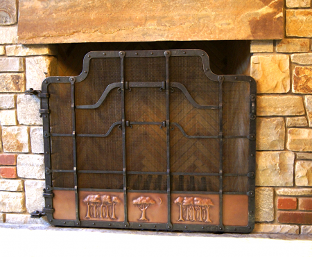 Wrought iron fire screen with copper panels and trees in repoussé